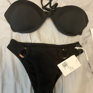 NWT! New with tags. Black bikini top, strapless or tied around neck.